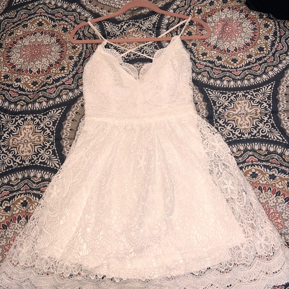 White lace dress. Straps cross in back